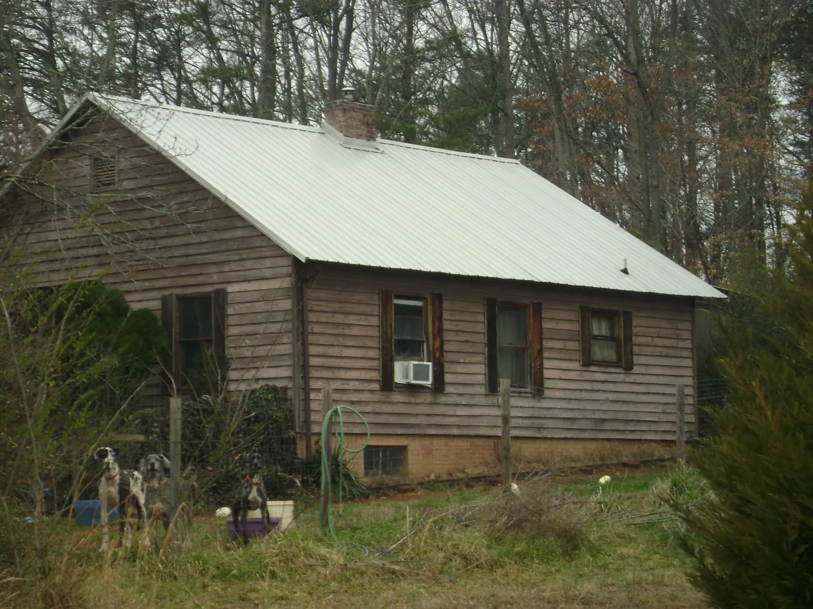 White metal roof on an old wood sided farmhouse, from a Metal Roof Installation job in Primm Springs